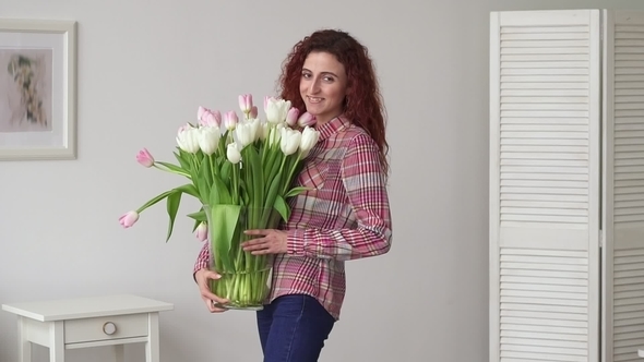 Happy Young Ginger Arabic Woman Dancing with Bunch of Tulips