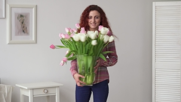 Happy Middle Eastern Girl Dancing with a Spring Bouquet of Flowers