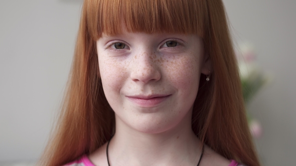 Face of a Little Happy Redheaded Girl with Freckles