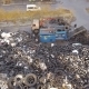 Processing of Wastes. The Truck Crane Loads Old Tires Into the Shredder for Recycling. Aerial View - VideoHive Item for Sale