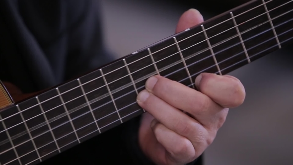 of an Italian Man Playing in the Church on a Guitar