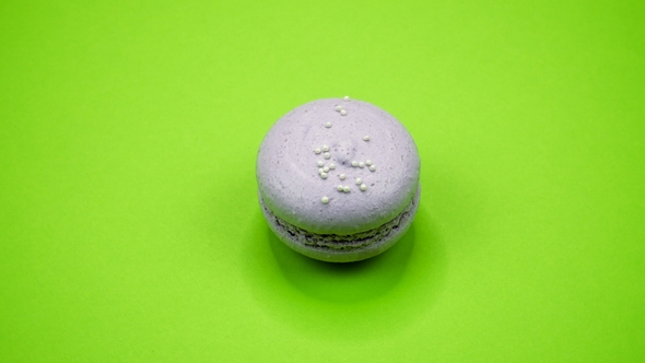 ROTATION: A Colorful Macaroons Are Rotating on a Green Background alt