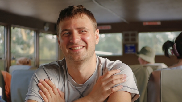 Portrait Handsome Caucasian Man Smiling Looking At Camera Sitting In Transport alt
