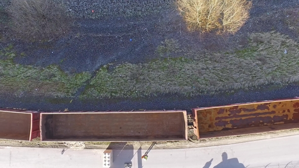Aerial of a Train Passing with Empty Wagons alt