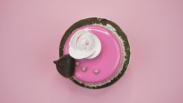 Bright and Colorful Cake  on a Pink Background. Rotating Top View. alt