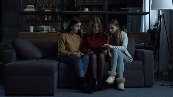 Pretty Girls Choosing Apparel While Shopping Online alt