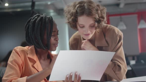 The Young African Teacher is Explaining Her Student How to Do the Task That She Gave Slow Motion