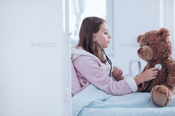 Sick girl and teddy bear - Stock Photo - Images