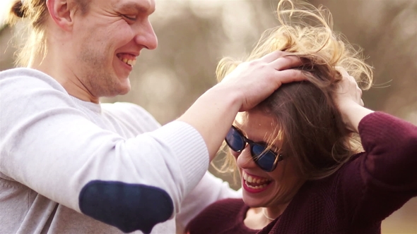 Young Couple in Love. A Man and a Woman Fool Around and Laugh. The Guy Ruffles the