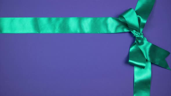 Two Silk Ribbons Form a Bow in the Corner. Festive Background for Advertising. Stop Motion alt