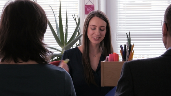 Team Work - A Businesswoman Takes Notes During a Project Meeting