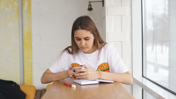 Young Girl Freelancer Uses Your Smartphone Window