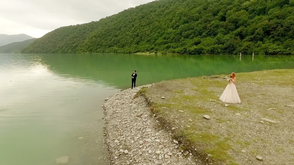 Loving Couple on the Background of the River and Mountains.
