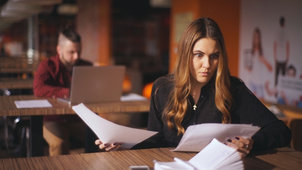 Businesswoman Looks at the Documents in Shock