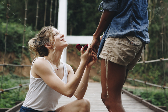 Woman proposing to her happy girlfriend outdoors love and marriage concept - Stock Photo - Images