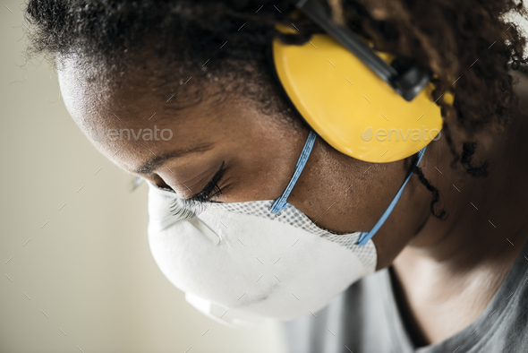 Black woman wearing ear protection