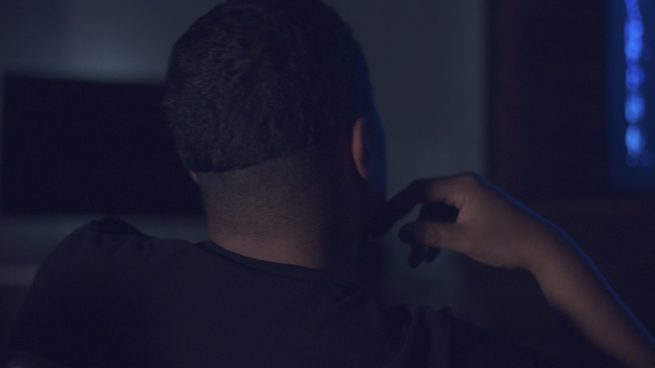 Upset Boring Mixed Race Man Watching Tv alt