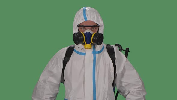 Portrait Male in a Protective Suit, Safety Glasses, Gloves and a Respirator Looks Confidently Into alt