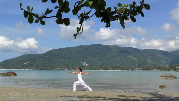 Woman Practicing Yoga at the Sea on Tropical Island