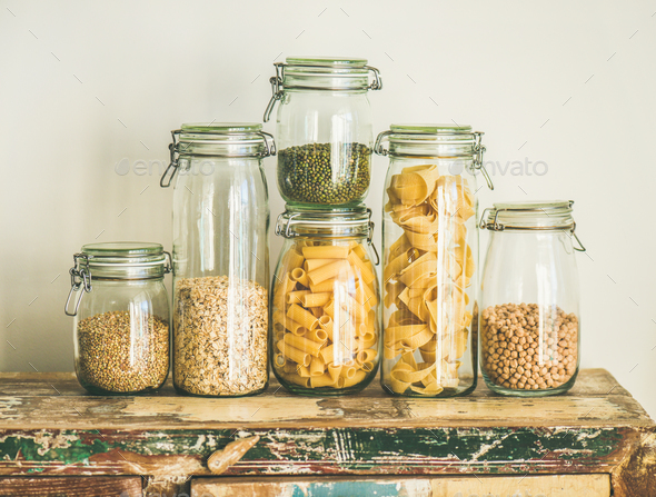 Uncooked cereals, grains, beans and pasta on rustic wooden table - Stock Photo - Images
