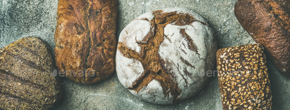 Top view of bread loaves over grey background - Stock Photo - Images