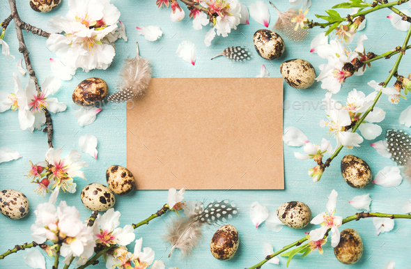 Easter background with eggs and almond flowers, paper in center - Stock Photo - Images