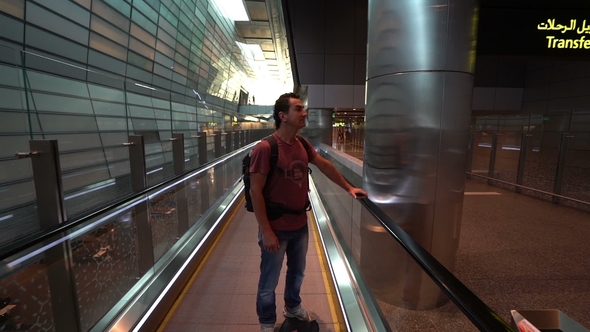 Man Lifting on Escalator at Airport Terminal, Passenger Looking Around Excited, Travel Concept