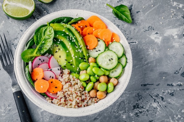 Vegan Buddha bowl salad with spinach, quinoa, roasted chickpeas, grilled chicken, avocado, edamame - Stock Photo - Images