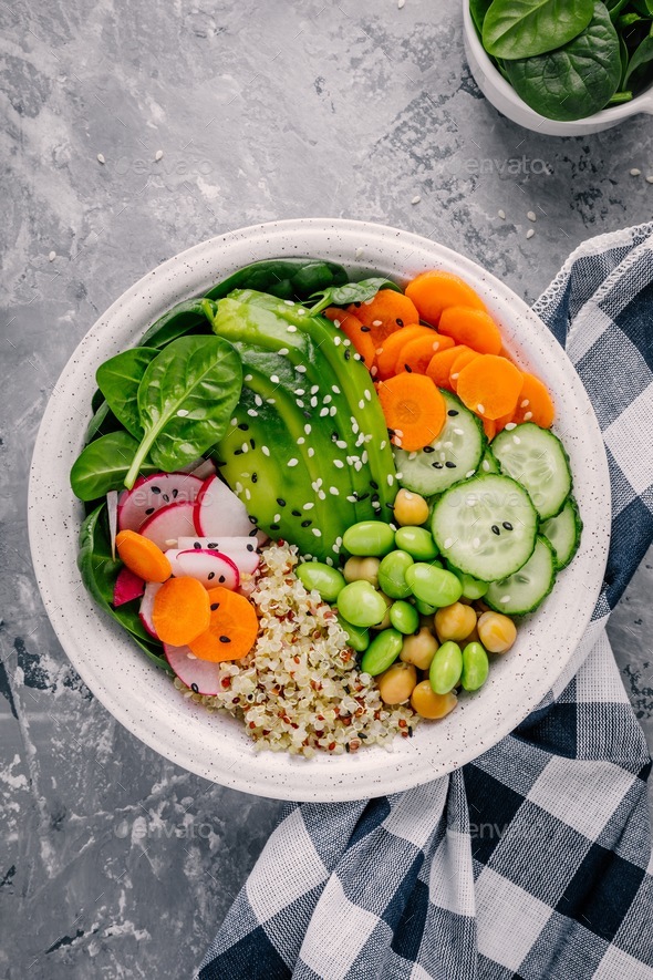 Vegan Buddha bowl salad with spinach, quinoa, roasted chickpeas, grilled chicken, avocado - Stock Photo - Images