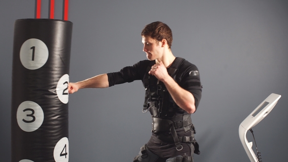 Boxer in Suit of Electric Stimulation in Gym. alt