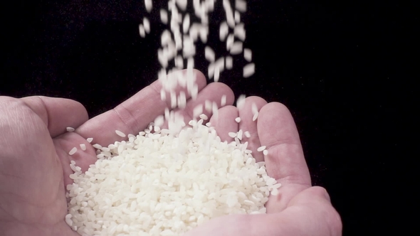 Rice Is Poured Into the Man's Palms