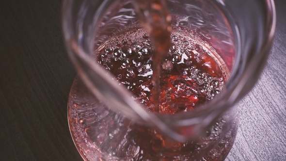 Rose Wine Pours Into the Decanter