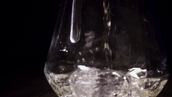 White Wine Pours Into the Carafe