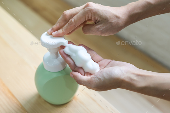 Close up of woman hand take cleaner foam