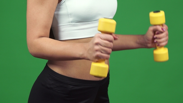 Cropped  of a Fitness Woman with Perfect Abs Exercising with Weights alt