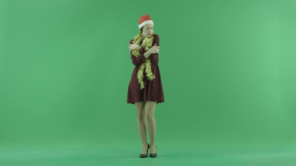 A Young Christmas Girl Is Feeling Cold on the Green Screen