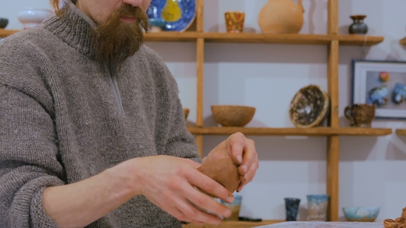 Professional Male Potter Making Ceramic Jug