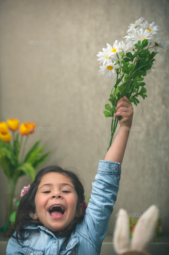 Excited baby girl with flowers - Stock Photo - Images