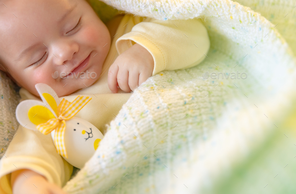Cute baby sleeping with Easter decorations - Stock Photo - Images
