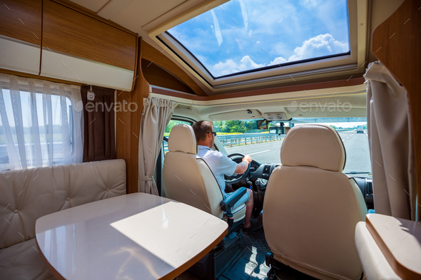 Man driving on a road in the Camper Van RV - Stock Photo - Images