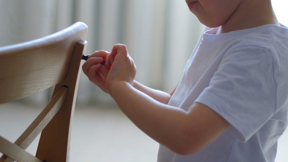 The Child Collects a Baby Chair By Tools