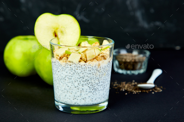Healthy chia pudding with apples and granola in glass. - Stock Photo - Images