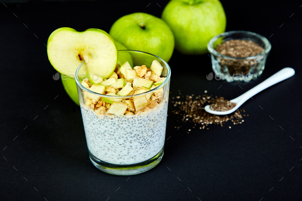 Healthy chia pudding with apples and granola in glass. - Stock Photo - Images