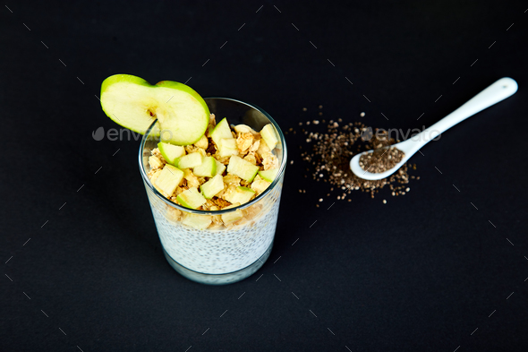 Healthy chia pudding with apples and granola in glass. - Stock Photo - Images