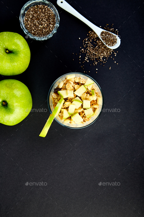 Healthy chia pudding with apples and granola in glass. - Stock Photo - Images