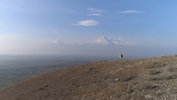 Hiker with Rucksack in Colorful Jacket Go to Look at Beautiful Scene alt