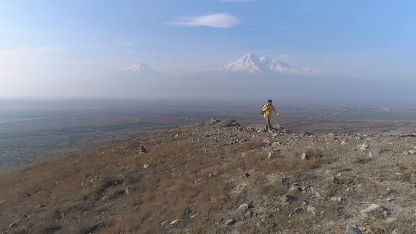 Hiker with Rucksack in Colorful Jacket Go to Look at Beautiful Scene alt