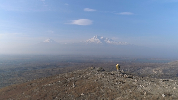 Aerial View Tourist Man Standing on the Mountain alt