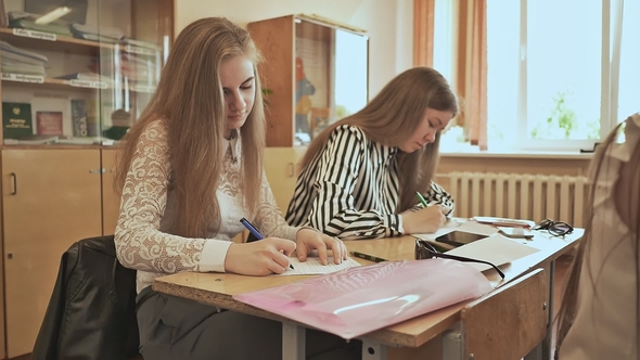 Russian School. Pupils Write a Control Exam in Their Notebooks alt