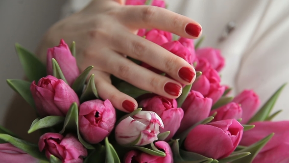 Young Romantic Woman with a Bouquet of Pink Tulips